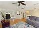 Spacious living room with dining area featuring hardwood floors, coffered ceilings, and modern decor at 5960 Sarah Orr Ln, Cumming, GA 30040