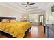 Spacious main bedroom features a tray ceiling, hardwood floors, and a large window at 5960 Sarah Orr Ln, Cumming, GA 30040