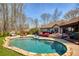 Backyard oasis features a sparkling in-ground pool, and outdoor furniture at 5960 Sarah Orr Ln, Cumming, GA 30040