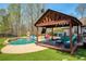 Backyard features a sparkling in-ground pool, outdoor seating and an outdoor kitchen at 5960 Sarah Orr Ln, Cumming, GA 30040