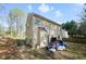 A backyard view of a two story house with light-colored siding at 792 Russell Dr, Riverdale, GA 30296