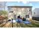 A backyard view of a two story house with light-colored siding at 792 Russell Dr, Riverdale, GA 30296