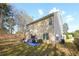 A backyard view of a two story house with light-colored siding at 792 Russell Dr, Riverdale, GA 30296
