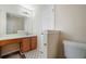 Bathroom featuring a toilet, sink with vanity and cabinet, mirror, and good lighting at 792 Russell Dr, Riverdale, GA 30296