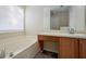 Bathroom vanity area with a large mirror, cabinet storage, and sink at 792 Russell Dr, Riverdale, GA 30296