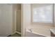 Bright bathroom featuring a soaking tub next to a glass enclosed shower at 792 Russell Dr, Riverdale, GA 30296