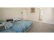 Bedroom with neutral walls and carpet, leading to the bathroom at 792 Russell Dr, Riverdale, GA 30296
