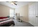 Bedroom with a fan, carpet, window and desk for utility at 792 Russell Dr, Riverdale, GA 30296