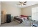 Bedroom with a fan, carpet, window and furnishings for storage and utility at 792 Russell Dr, Riverdale, GA 30296