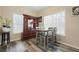 Dining area with natural light and modern gray floors. Classic wood china cabinet at 792 Russell Dr, Riverdale, GA 30296