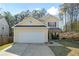 Charming two-story home with a two-car garage and well-maintained landscaping at 792 Russell Dr, Riverdale, GA 30296