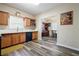 Spacious kitchen area leading to dining nook with gray wood-look floors and natural light at 792 Russell Dr, Riverdale, GA 30296