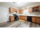 Well-lit kitchen with oak cabinets, laminate floors, and stainless steel appliances at 792 Russell Dr, Riverdale, GA 30296