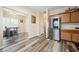 Bright kitchen area with stainless steel refrigerator, gray flooring, and breakfast nook with natural lighting at 792 Russell Dr, Riverdale, GA 30296