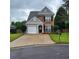 Charming two-story home with brick and siding exterior and well-maintained front yard with driveway and landscaping at 1503 Korona Ct, Woodstock, GA 30188