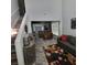 Open-concept living room featuring hardwood floors, high ceilings, natural light, modern decor, and seamless flow into dining area at 1503 Korona Ct, Woodstock, GA 30188