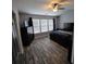 Spacious main bedroom with hardwood floors, vaulted ceiling, ample natural light, and contemporary furnishings creating a relaxing retreat at 1503 Korona Ct, Woodstock, GA 30188