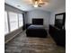 Bright main bedroom featuring hardwood floors, large windows, contemporary decor, and spacious layout with ceiling fan at 1503 Korona Ct, Woodstock, GA 30188
