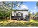 Spacious backyard featuring a dark wooden deck, stairs, a grassy lawn, and mature trees at 2425 Shiloh Sw Dr, Marietta, GA 30064