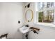 Bright bathroom with a modern sink, striking a balance of rustic charm and contemporary design at 2425 Shiloh Sw Dr, Marietta, GA 30064