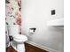 Cozy half-bath featuring vibrant floral wallpaper and modern fixtures, creating a unique and inviting space at 2425 Shiloh Sw Dr, Marietta, GA 30064
