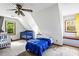 Sloped ceiling bedroom with two cribs and a single bed, maximizing the space for a cozy, Gathering-friendly atmosphere at 2425 Shiloh Sw Dr, Marietta, GA 30064