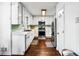 Modern kitchen with stainless appliances, white cabinets, and hardwood floors at 2425 Shiloh Sw Dr, Marietta, GA 30064