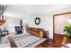 Cozy living room with leather sofa, fireplace, hardwood floors, and stylish decor at 2425 Shiloh Sw Dr, Marietta, GA 30064