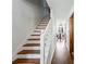 Elegant staircase with wooden treads and white risers leading to an open dining area, enhancing the home's charm at 2425 Shiloh Sw Dr, Marietta, GA 30064