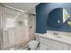 Bathroom with blue accent wall, glass shower and marble tile at 250 Martin Ridge Ct, Roswell, GA 30076