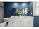 Bathroom with blue walls, double vanity with white cabinets, marble countertop and round mirrors at 250 Martin Ridge Ct, Roswell, GA 30076