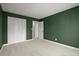Green bedroom featuring carpet, a door and a wardrobe at 250 Martin Ridge Ct, Roswell, GA 30076