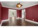 View of the dining room showcasing hardwood floors, contemporary lighting, and bright red paint at 250 Martin Ridge Ct, Roswell, GA 30076