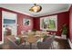 Formal dining room features hardwood floors, contemporary lighting, and bright red paint at 250 Martin Ridge Ct, Roswell, GA 30076