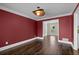 The dining room shows hardwood floors, contemporary lighting, and bright red paint at 250 Martin Ridge Ct, Roswell, GA 30076