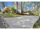 Long driveway leading to a home with a well-maintained lawn and mature trees offering shade and privacy at 250 Martin Ridge Ct, Roswell, GA 30076