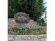 Beautiful stone community entrance sign surrounded by colorful flowers and greenery at 250 Martin Ridge Ct, Roswell, GA 30076