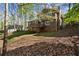 View of a two-story home featuring a brick foundation and a wooden deck at 250 Martin Ridge Ct, Roswell, GA 30076