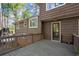 The back of this two-story home features a wooden deck and a glass paned door at 250 Martin Ridge Ct, Roswell, GA 30076