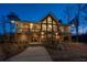 Stunning exterior view of a stone and wood home with large windows and a spacious deck at 250 Martin Ridge Ct, Roswell, GA 30076