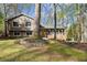Traditional home with a covered porch, beautiful landscaping, and mature trees offering a sense of privacy at 250 Martin Ridge Ct, Roswell, GA 30076