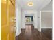Bright foyer with hardwood floors, view into another room, and an inviting yellow entry door at 250 Martin Ridge Ct, Roswell, GA 30076