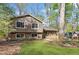 Traditional-style home with a manicured lawn and a covered front porch, nestled amongst mature trees at 250 Martin Ridge Ct, Roswell, GA 30076