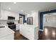 Open kitchen with white cabinets, stainless steel appliances, and hardwood floors at 250 Martin Ridge Ct, Roswell, GA 30076