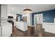 Open kitchen layout with stainless steel appliances, white cabinetry, and view to dining area at 250 Martin Ridge Ct, Roswell, GA 30076