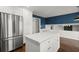 Large kitchen with white island, stainless fridge, and hardwood floors at 250 Martin Ridge Ct, Roswell, GA 30076