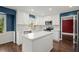 Modern kitchen with white cabinets, stainless appliances, and hardwood floors at 250 Martin Ridge Ct, Roswell, GA 30076
