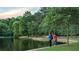 Beautiful lake view showcasing recreational fishing, lush green trees, and a peaceful environment at 250 Martin Ridge Ct, Roswell, GA 30076