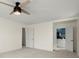Spacious main bedroom featuring neutral carpet and ceiling fan with light fixture, leading into the ensuite bathroom at 250 Martin Ridge Ct, Roswell, GA 30076