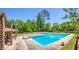 Community pool area with lounge chairs, diving boards, stone supports, and mature trees around the area at 250 Martin Ridge Ct, Roswell, GA 30076
